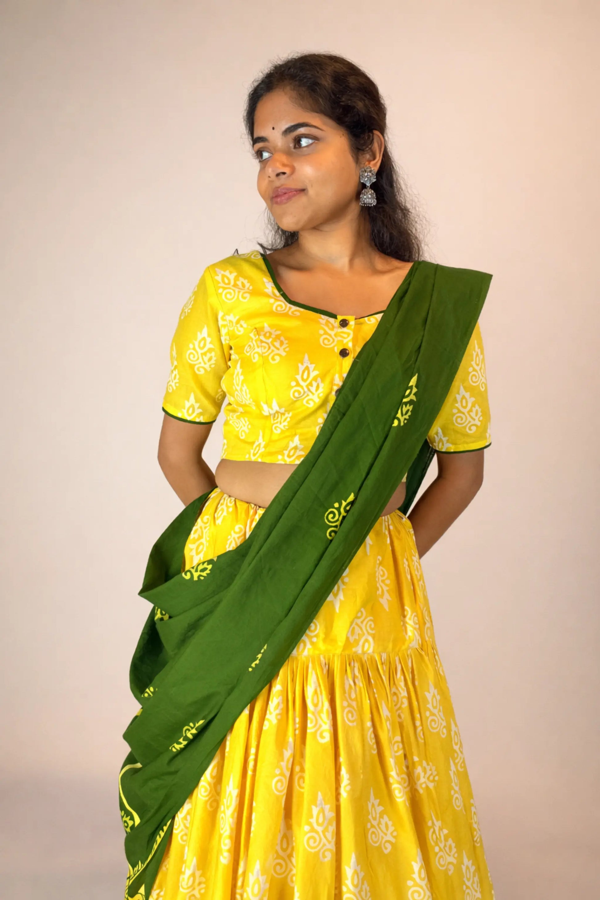 Detailed view of green hand block print dupatta paired with Basantika yellow gopi skirt set