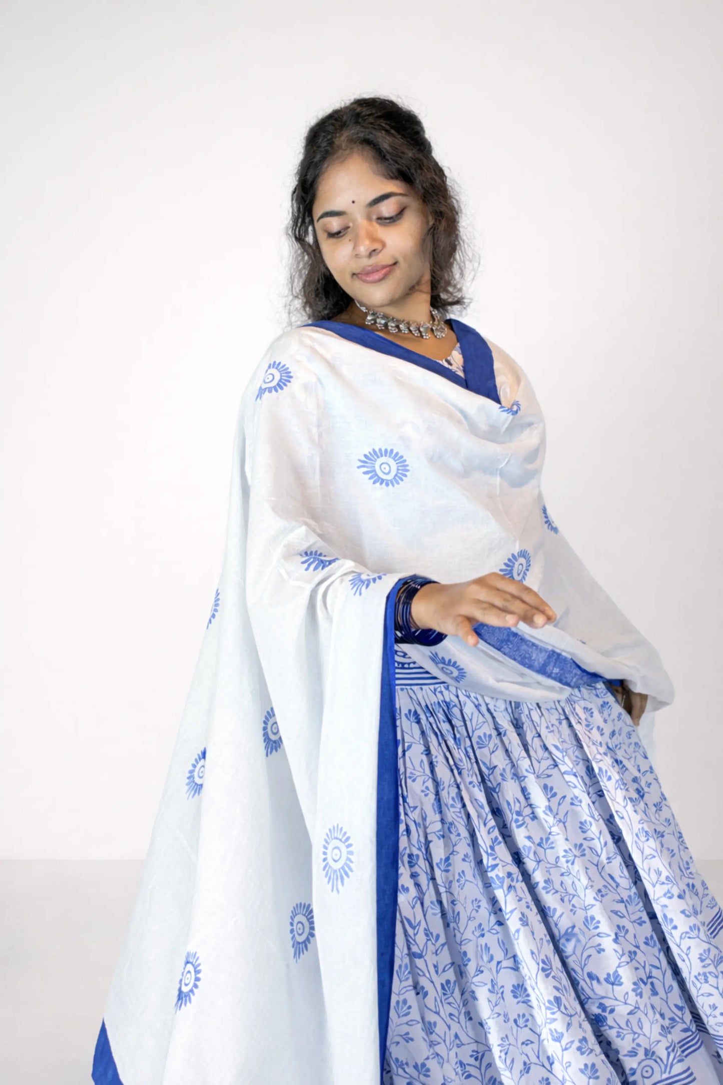 Elegant pose highlighting the flowing dupatta of a blue and white block print Charubala cotton gopi dress
