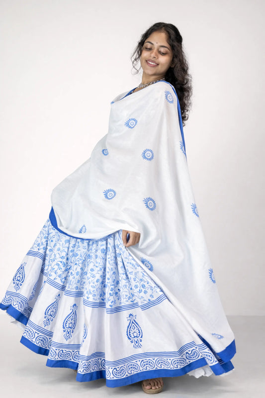 Full-length view of a model wearing a blue and white block print Charubala cotton gopi dress in a studio setting