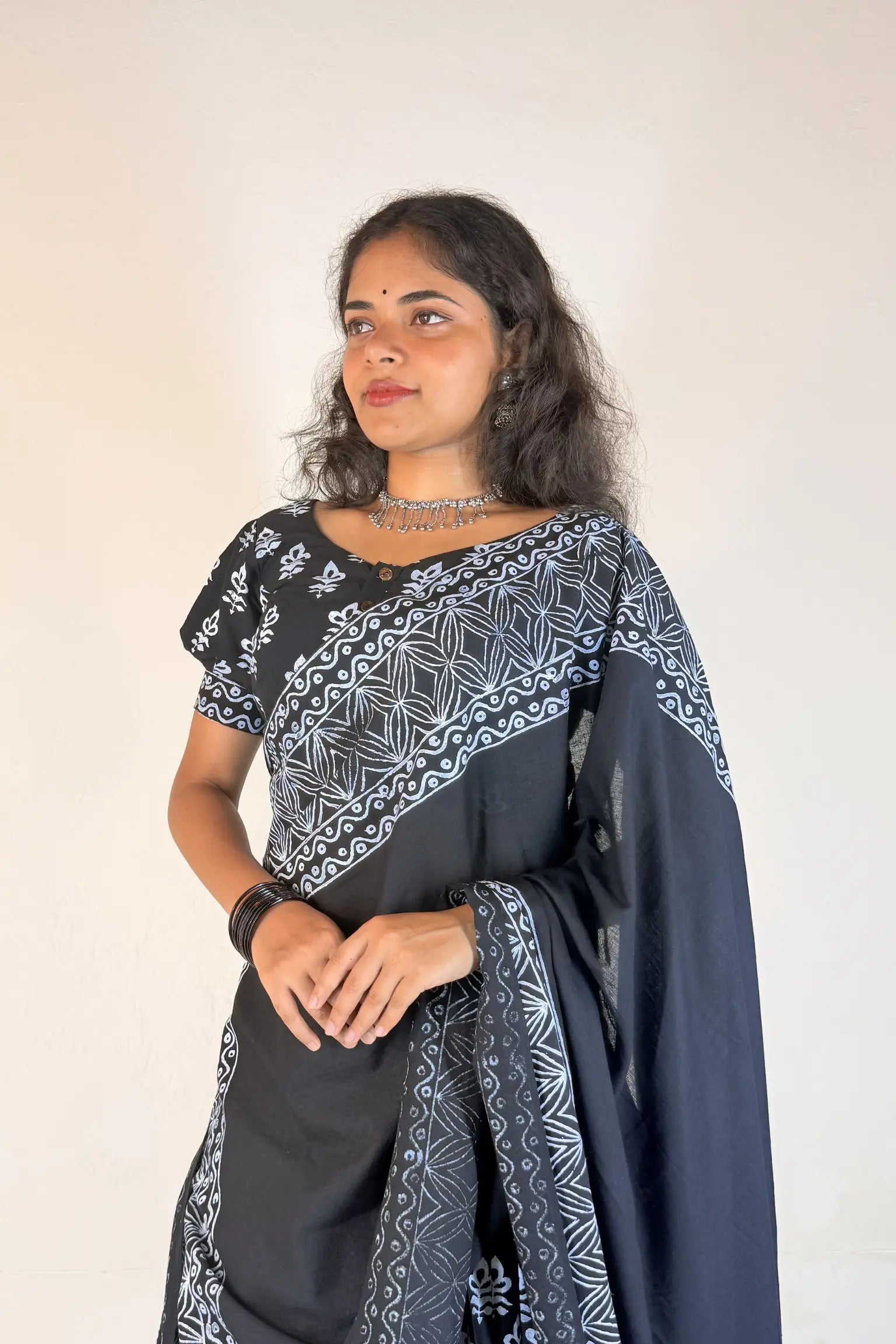 Woman wearing a black and white patterned Gopi Skirt Set against a plain background