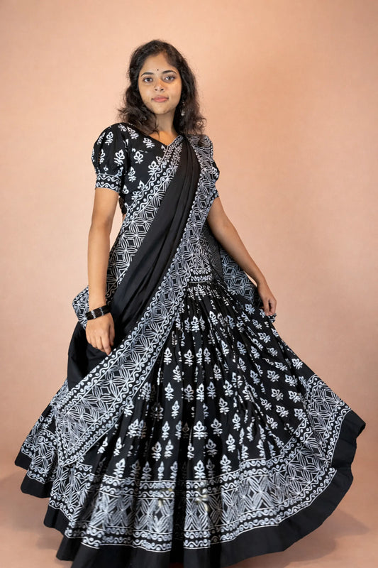 Kalindi handcrafted block print cotton gopi dress in black and white, flowing silhouette shown in a graceful movement pose