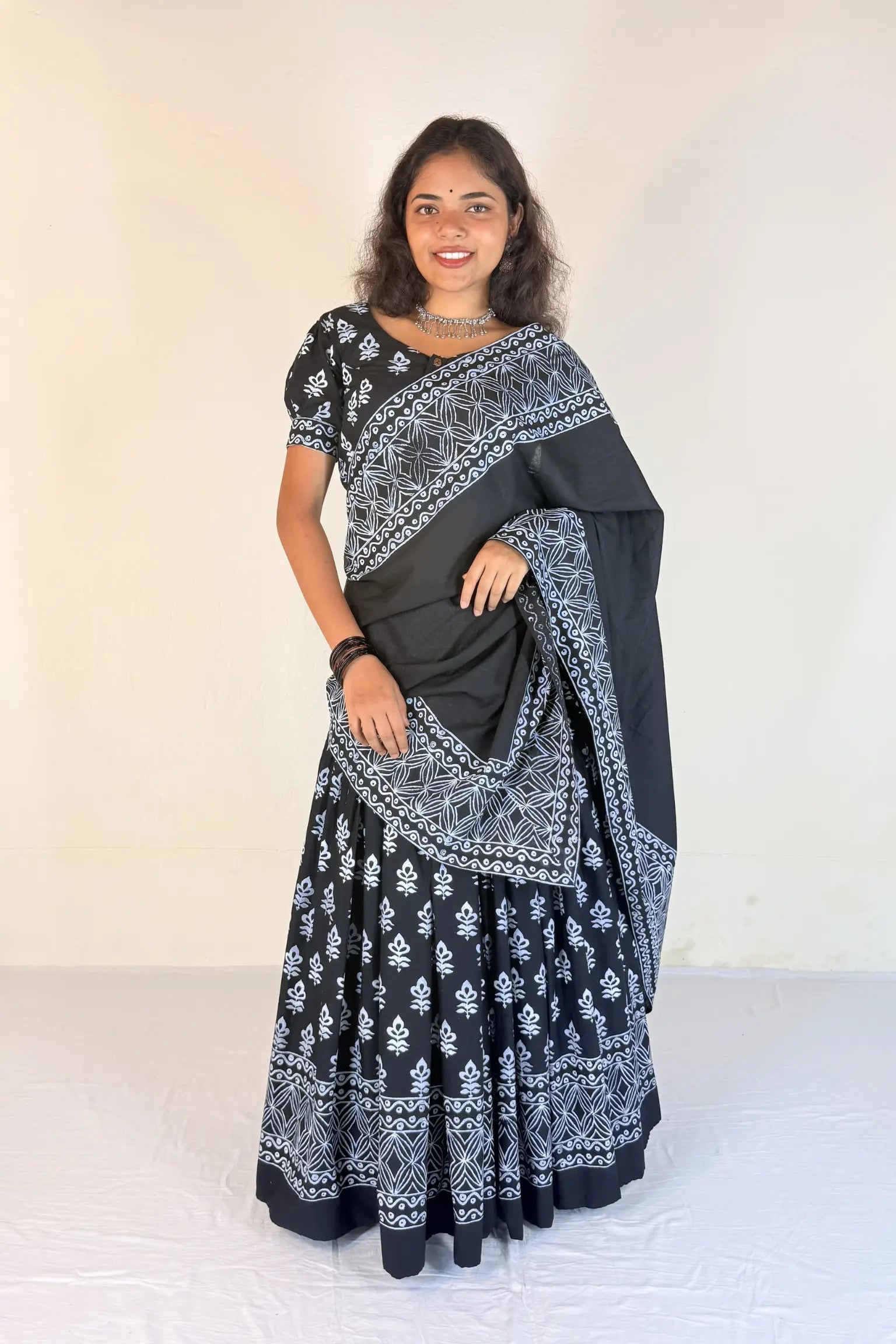 Woman wearing a colorful gopi dress with a plain background