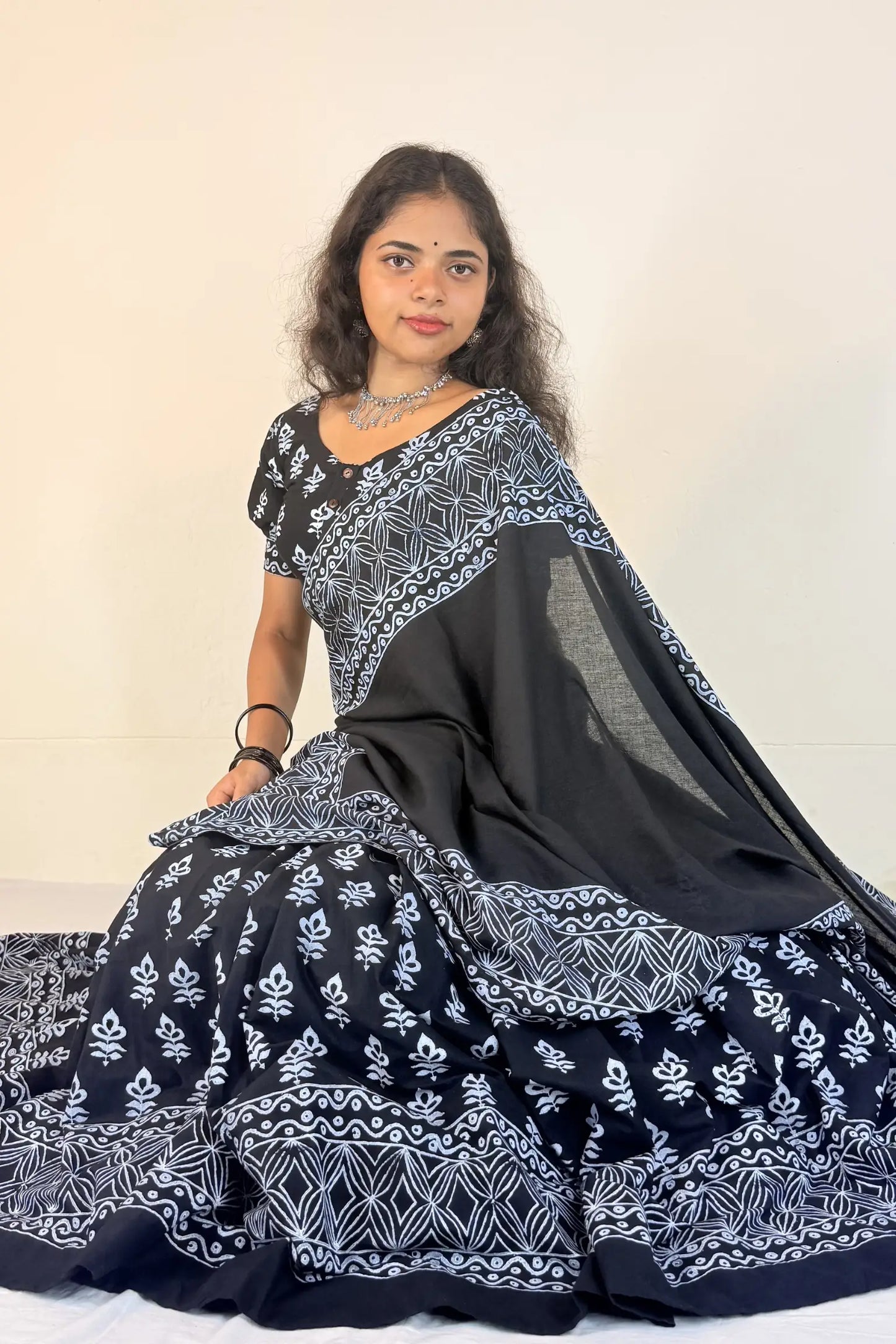 Woman wearing a black and white patterned Gopi Skirt Set against a plain background