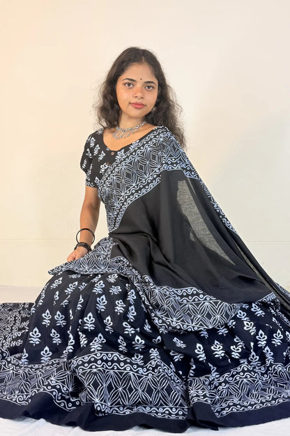Woman wearing a black and white patterned Gopi Skirt Set against a plain background