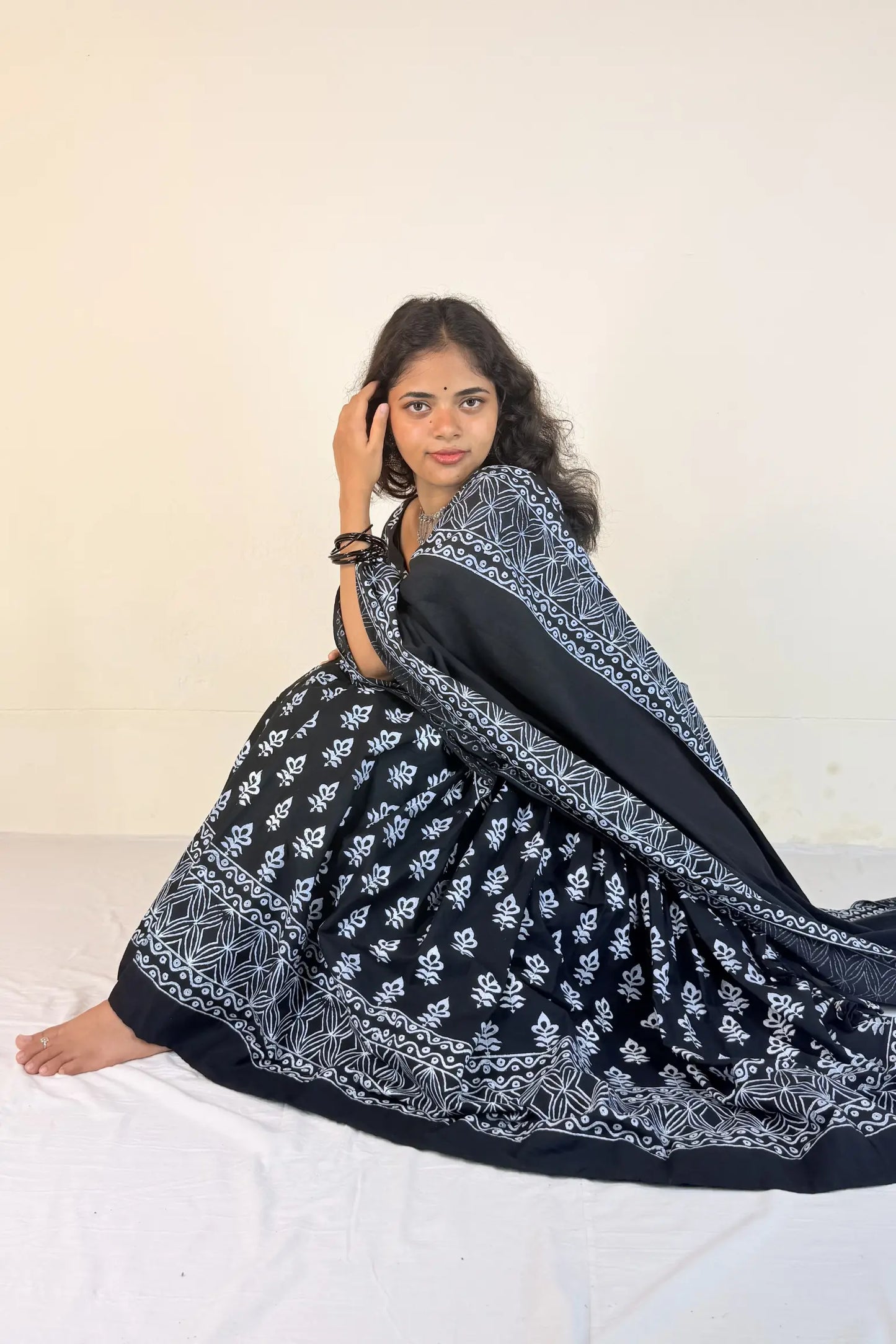 Woman wearing a black and white patterned Gopi Dress on a white background