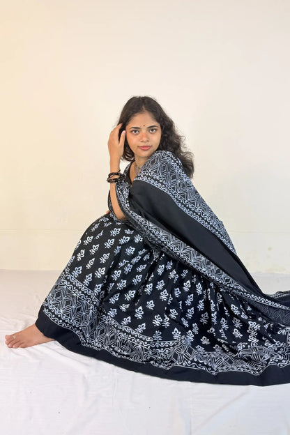 Woman wearing a black and white patterned Gopi Dress on a white background