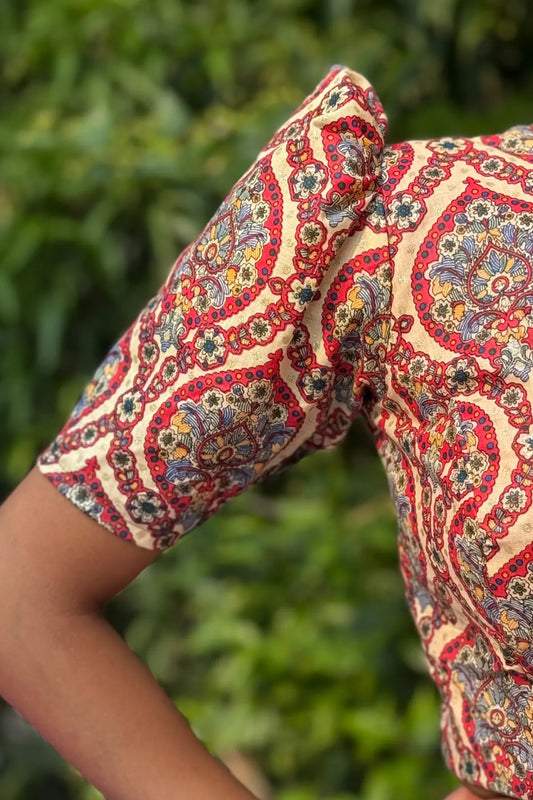Detailed view of handcrafted cotton blouse sleeve with intricate paisley block print and fine stitching