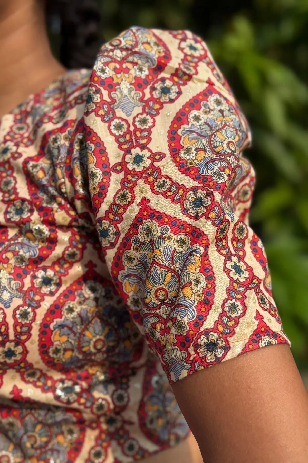 Close-up of short sleeve on cotton paisley block print blouse, showcasing fabric texture and print detail