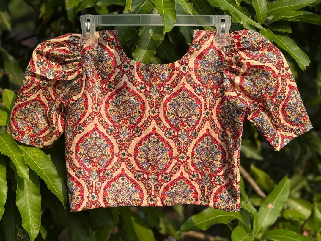 Back view of handcrafted cotton blouse featuring paisley block print with red contrast lining