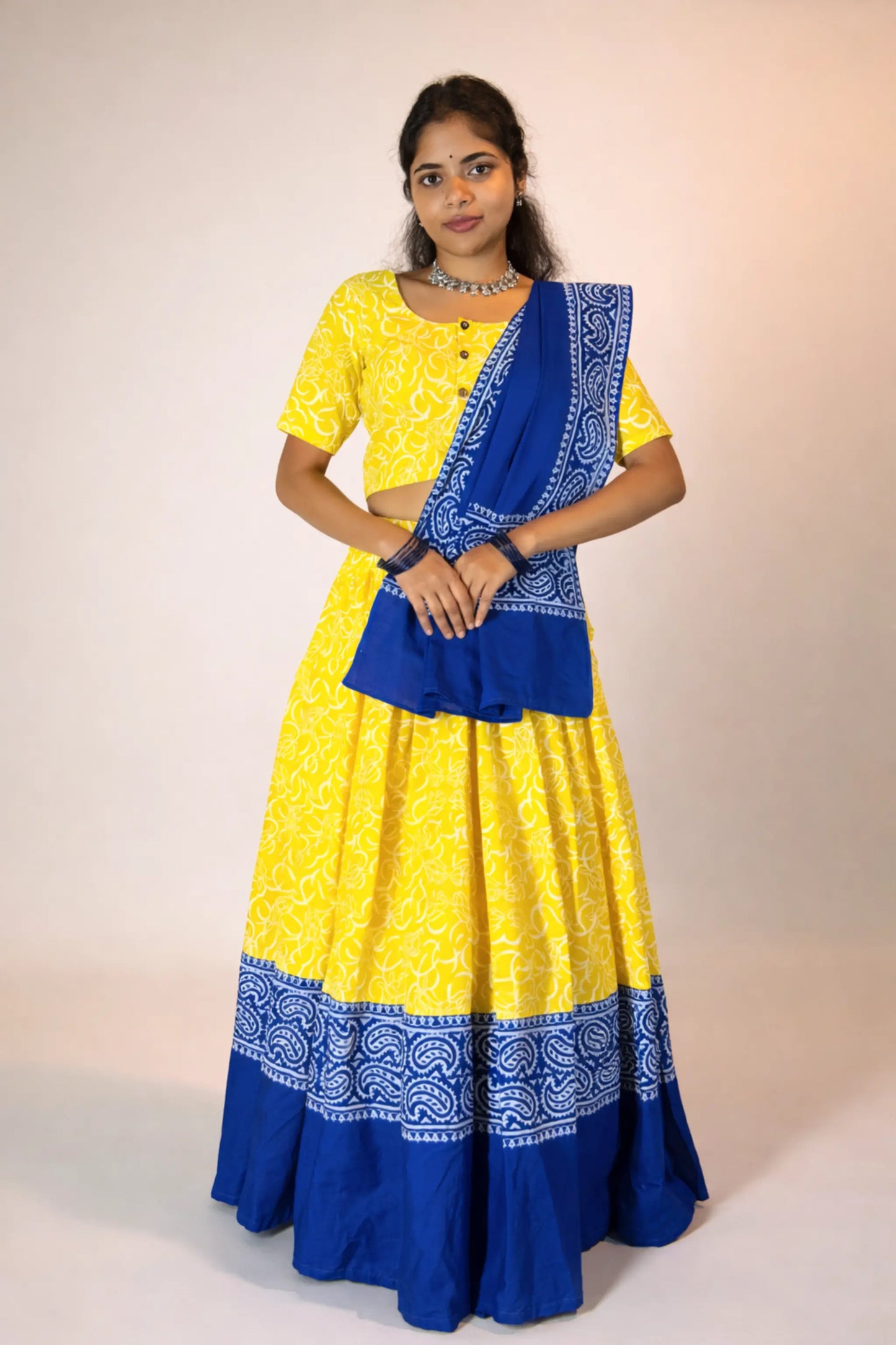 Front mid-length view of Neelambari yellow and blue hand block print gopi skirt set