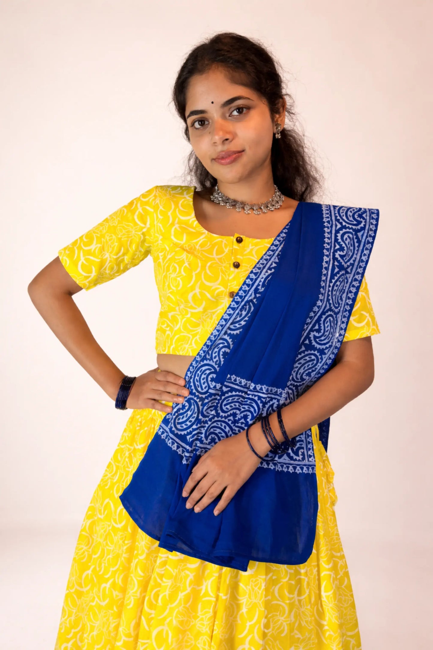 Angled portrait view of Neelambari yellow and blue hand block print pure cotton gopi skirt set