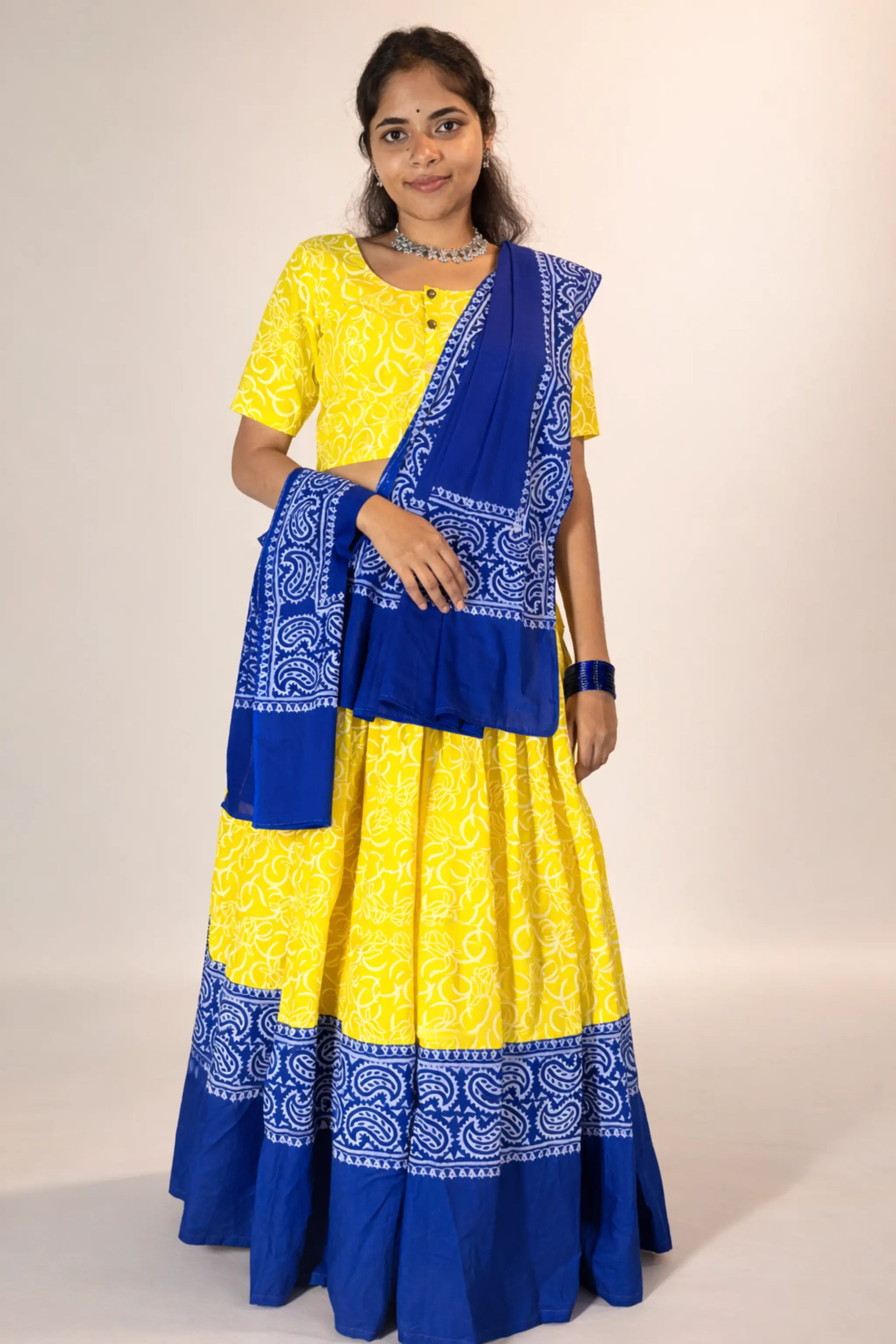 Full front standing pose of Neelambari yellow blue hand block print pure cotton gopi skirt set