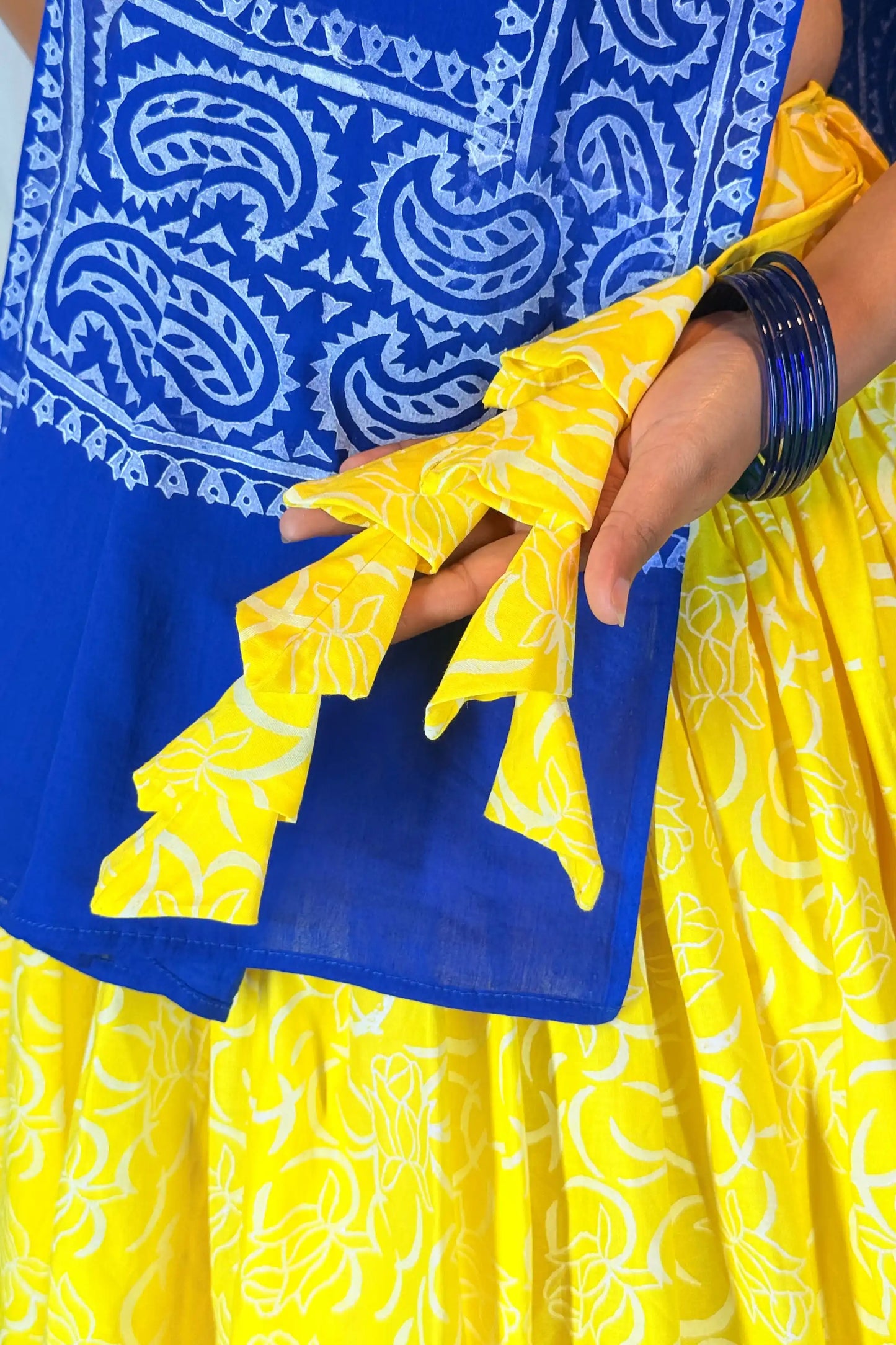 Close-up of hand block print tassel detail on pure cotton Neelambari yellow and blue gopi skirt set
