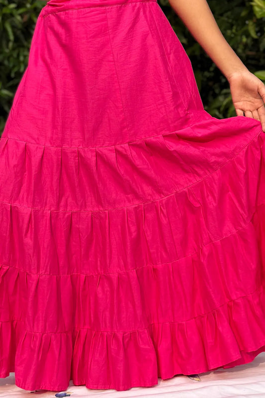 Full-length view of a bright pink cotton petticoat with layered tiered design, lightweight fabric, and smooth fall.