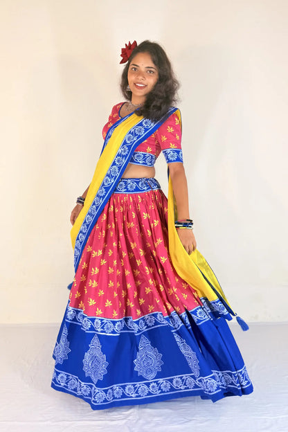 Woman wearing a colorful traditional outfit with a yellow and blue Gopi Dress on a white background