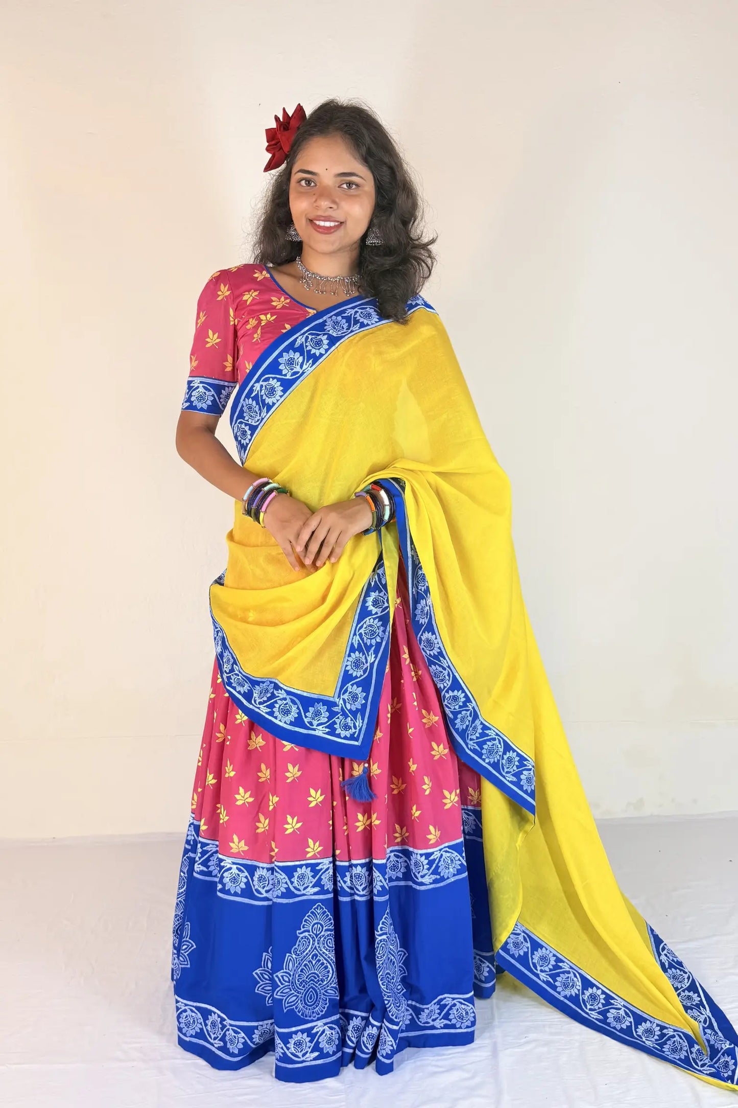 Woman wearing a colorful Gopi Dress with a yellow background