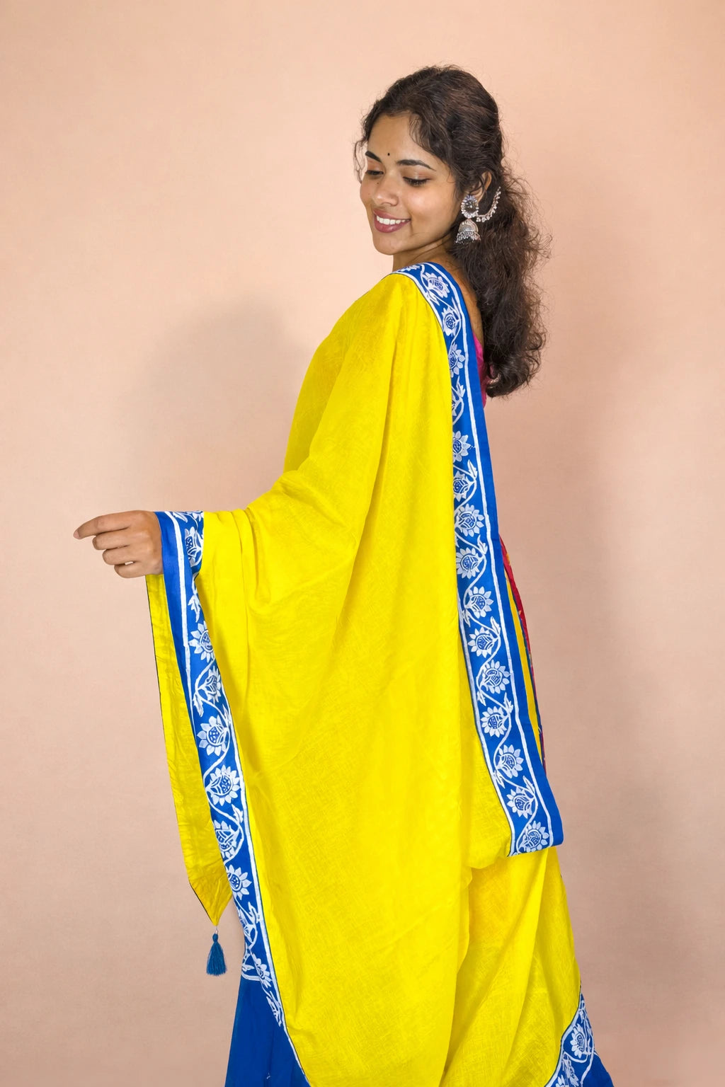 Side profile of Rasika Rangini hand block printed Gopi dress with traditional yellow dupatta and blue border