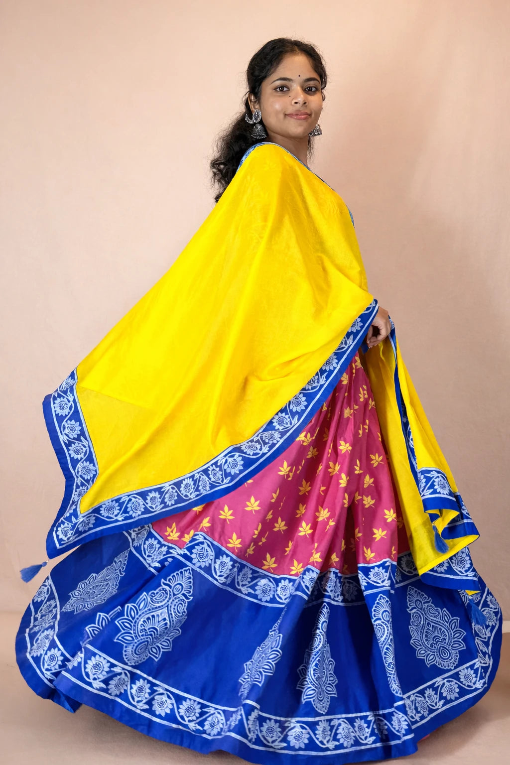 Full flare Rasika Rangini Gopi dress featuring pink hand block printed skirt with blue border and yellow dupatta