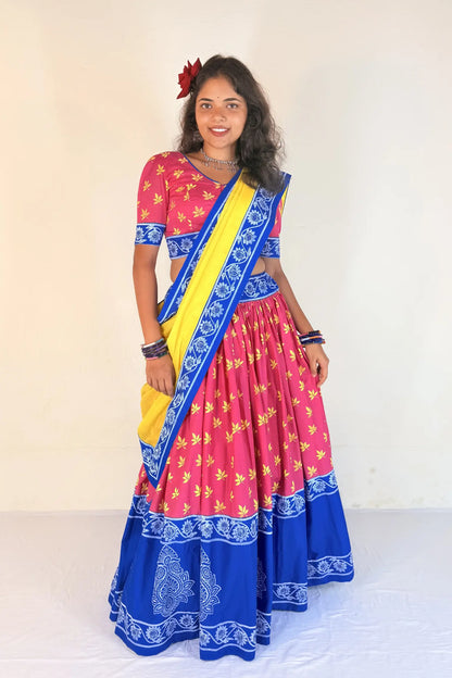 Woman wearing a colorful Gopi Dress with a plain background