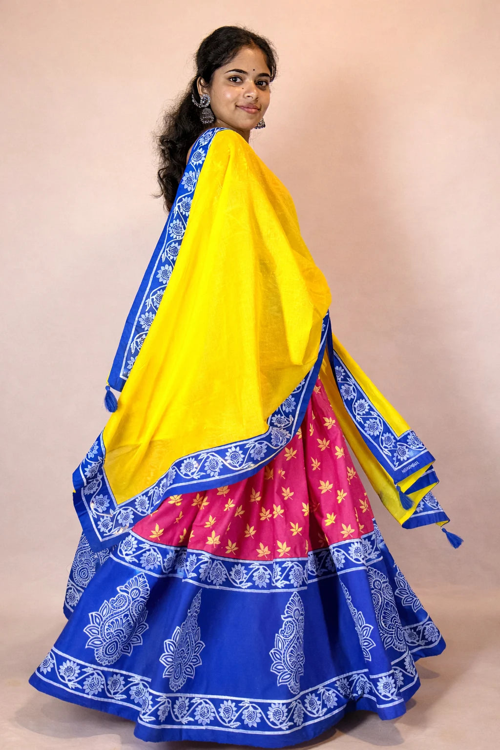 Side view of Rasika Rangini Gopi dress with hand block print, yellow dupatta and blue floral border details