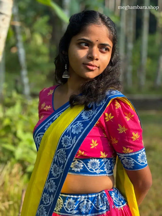 Woman wearing a colorful traditional outfit with a blurred natural background