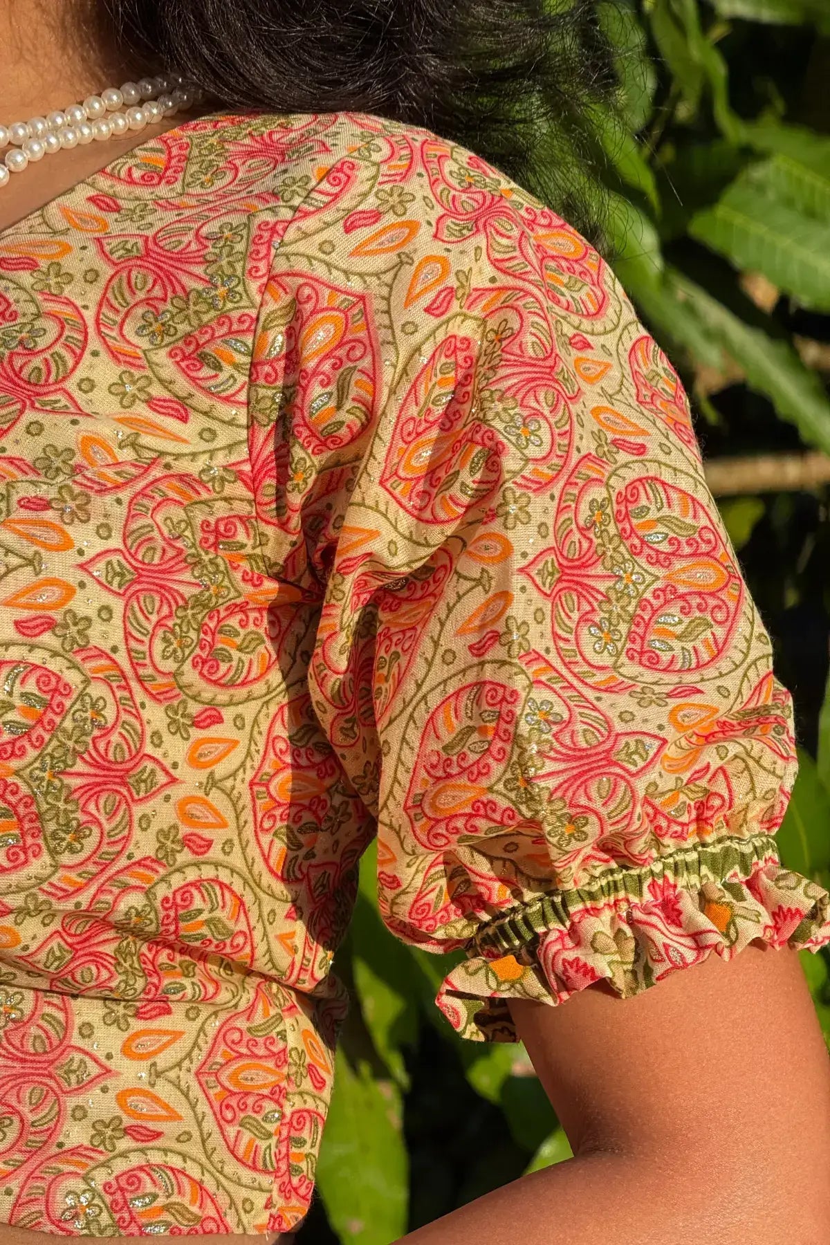 Handcrafted Surangini cotton blouse sleeve detail with traditional folk paisley print by Meghambara